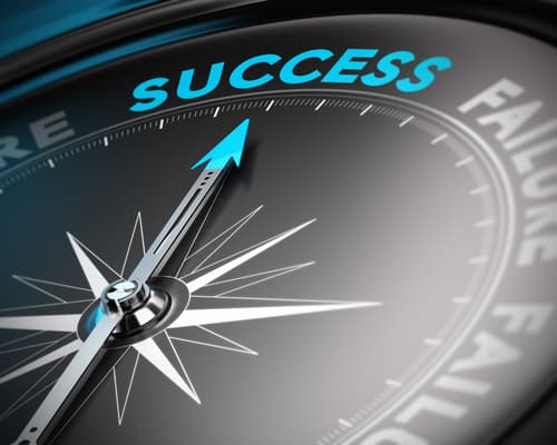 A compass needle pointing to the word Success rather than Failure